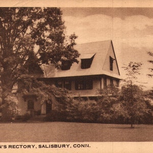 May include: A black and white vintage postcard image of a two-storey house with a gabled roof. The house is surrounded by trees and bushes. The text on the postcard reads "St. John's Rectory, Salisbury, Conn."