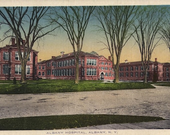 May include: A vintage postcard depicting a red brick building with multiple windows. The building is surrounded by trees and a grassy lawn. The text "ALBANY HOSPITAL, ALBANY, N.Y." is printed at the bottom of the postcard.