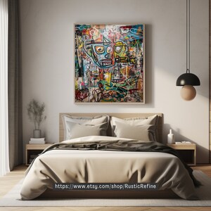 May include: A colorful abstract painting with a large, cartoon-like face in the center. The painting is framed and hanging on a wall above a bed with beige linens.