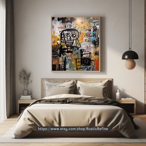 Peut inclure: Peinture abstraite avec une figure de cr&acirc;ne en noir et blanc, entour&eacute;e de formes g&eacute;om&eacute;triques color&eacute;es et de texte. La peinture est encadr&eacute;e et accroch&eacute;e au mur au-dessus d'un lit avec des draps beiges.