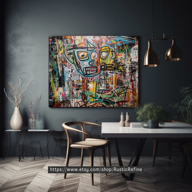 May include: A colorful abstract painting with a black frame, featuring two faces with bold lines and bright colors. The painting is hanging on a dark gray wall above a white table with a wooden chair.