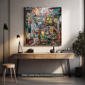 May include: A colorful abstract painting with a large, stylized face in the center. The painting is framed and hanging on a wall above a wooden desk with black metal legs. There is a plant in a black pot to the right of the desk.