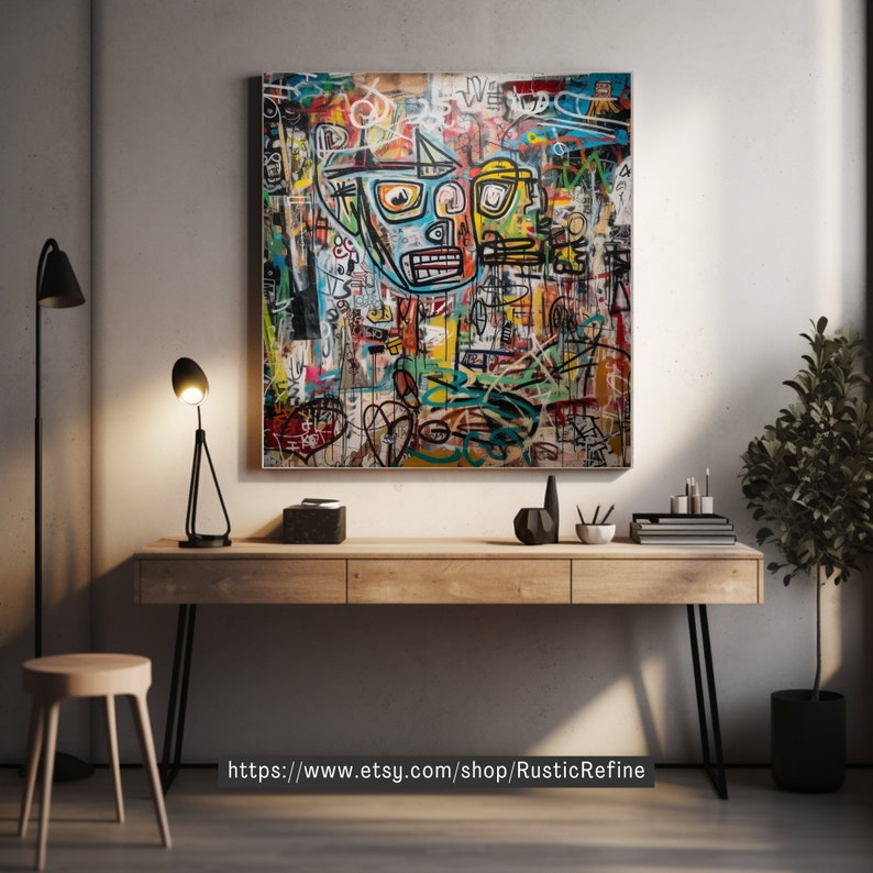 May include: A colorful abstract painting with a large, stylized face in the center. The painting is framed and hanging on a wall above a wooden desk with black metal legs. There is a plant in a black pot to the right of the desk.