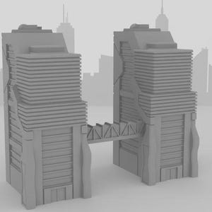 May include: A grey model of two skyscrapers linked by a bridge. The buildings have a layered design. The background shows a blurred cityscape silhouette.