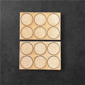 May include: Two wooden trays with 9 circular cutouts each. The trays are made of light brown wood and have a natural finish. The cutouts are designed to hold small round objects, such as coins or buttons.