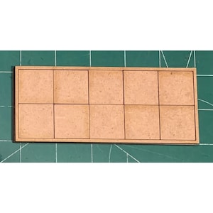 May include: A wooden board with nine squares, each with a light brown surface. The squares are separated by thin lines.