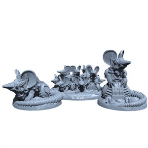 May include: A group of gray, robotic, mouse-like figures with large ears and mechanical details. The figures are posed in a variety of positions, some standing, some sitting, and some crawling. The figures are made of a smooth, gray plastic and have a slightly metallic sheen.