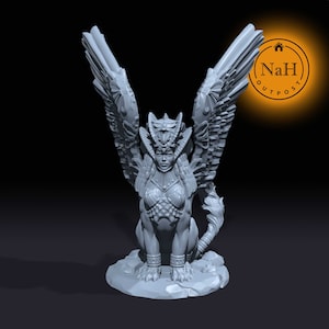 May include: A grey 3D printed miniature of a winged female creature with a feline body, wearing a crown and jewellery. The creature has large wings and a long tail. The miniature is sitting on a rocky base.