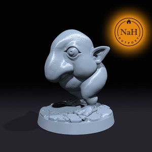 May include: A light gray figurine of a creature with a large nose, one eye, and large ears. The figurine is standing on a textured, circular base. The NaH Outpost logo is in the upper right corner.