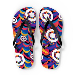 May include: A pair of black flip-flops with a colorful geometric pattern featuring hexagons and curved lines in shades of blue, red, yellow, orange, and purple.