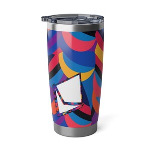 May include: A stainless steel tumbler with a colorful abstract design featuring blue, red, yellow, and purple geometric shapes. The tumbler has a lid and a silver base.