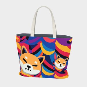 May include: A large tote bag featuring a Shiba Inu dog design. The bag has a colorful abstract pattern in the background with shades of blue, red, yellow, and purple. The bag has white handles.