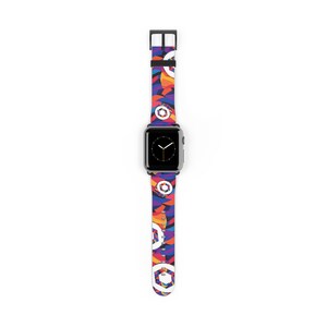 May include: A black Apple Watch with a colorful geometric patterned band. The band features a repeating pattern of circles and hexagons in shades of red, orange, yellow, blue, and purple.