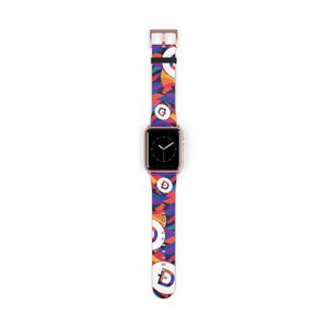 May include: A colorful Apple Watch band with a geometric pattern and a white logo. The band is made of silicone and has a rose gold buckle.
