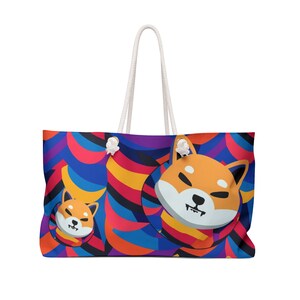 May include: Large tote bag with a colorful abstract pattern in blue, red, yellow, and purple. The bag features a cartoon Shiba Inu dog design. It has white rope handles.