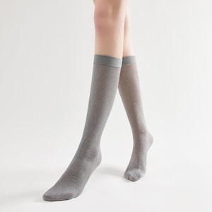 May include: A pair of silver sparkly knee-high socks.