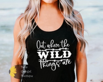 May include: Black tank top with white text that reads "Out where the WILD things are" with barbed wire accents.
