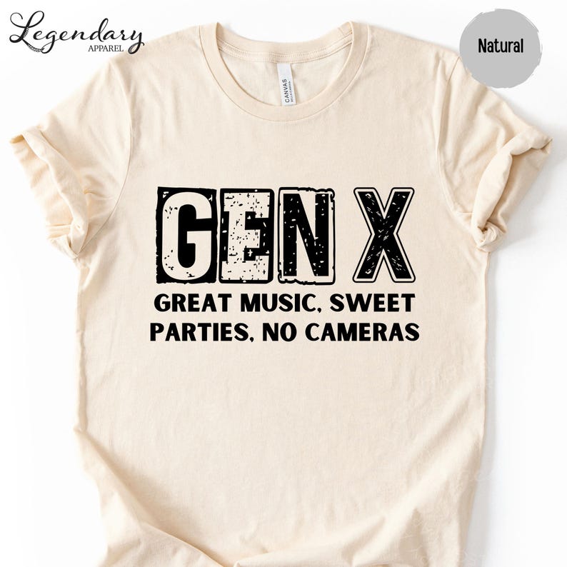 a beige t-shirt with a bold, graphic design that reads "GENX" in large letters. Below the text, it says "GREAT MUSIC. SWEET PARTIES. NO CAMERAS".