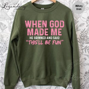 A green sweatshirt with a humorous text printed on it.
