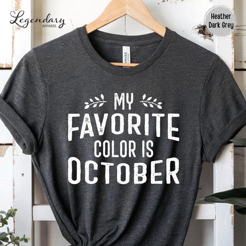 A gray t-shirt with the text "My Favorite Color Is October" printed on it.