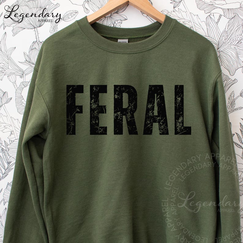 A green sweatshirt with the word "FERAL" printed in large, distressed letters across the front.