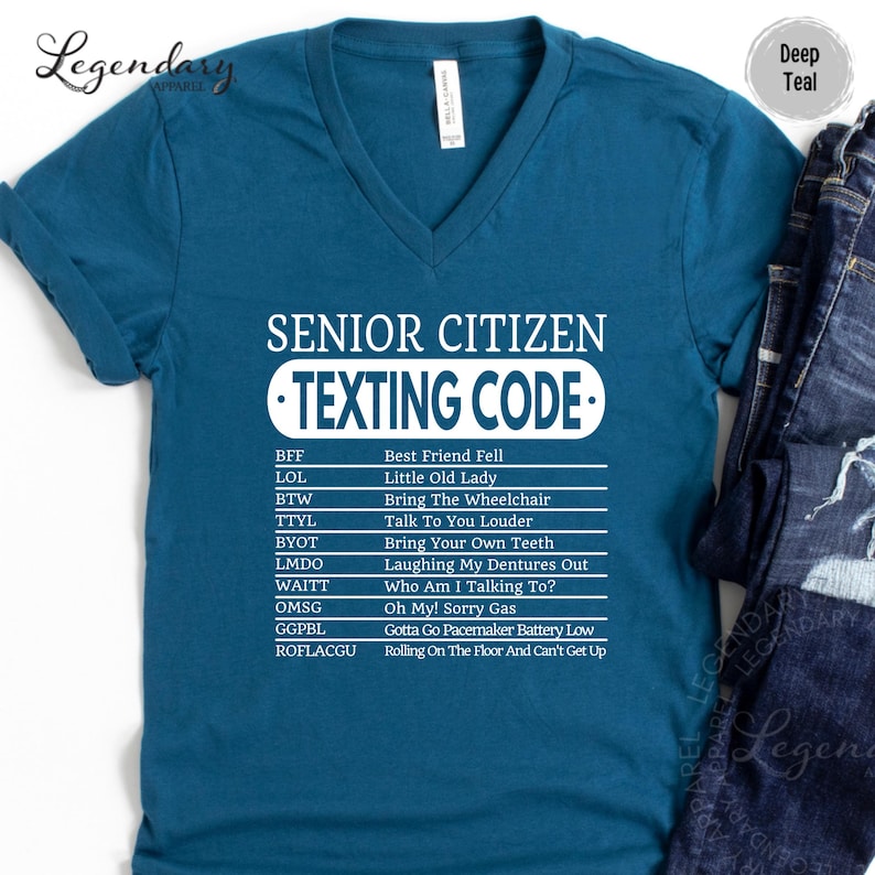 A blue t-shirt with a humorous text printed on it, which appears to be a list of various texts or phrases that are meant to be interpreted as a "texting code" for senior citizens.