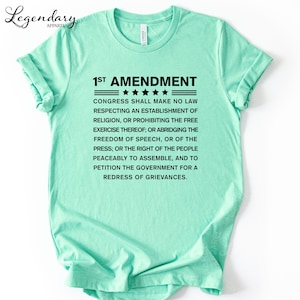 A mint green t-shirt with text printed on it.