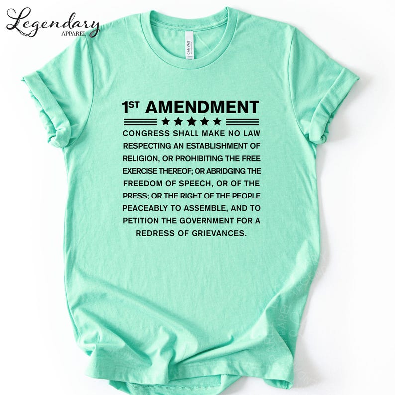 A mint green t-shirt with text printed on it.