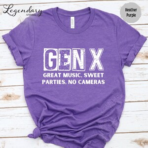 A purple t-shirt with the text "GENX" printed on it, along with the text "GREAT MUSIC, SWEET PARTIES, NO CAMERAS" printed below.