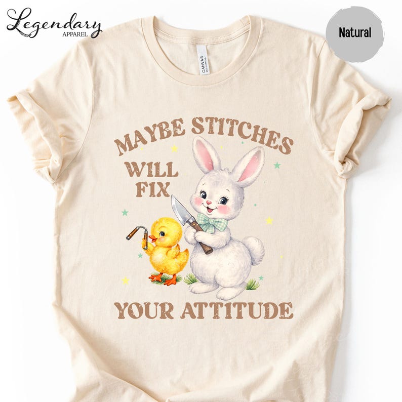a t-shirt with a cartoon rabbit and a yellow duck, along with the text "MAYBE STITCHS WILL FIX YOUR ATTITUDE".