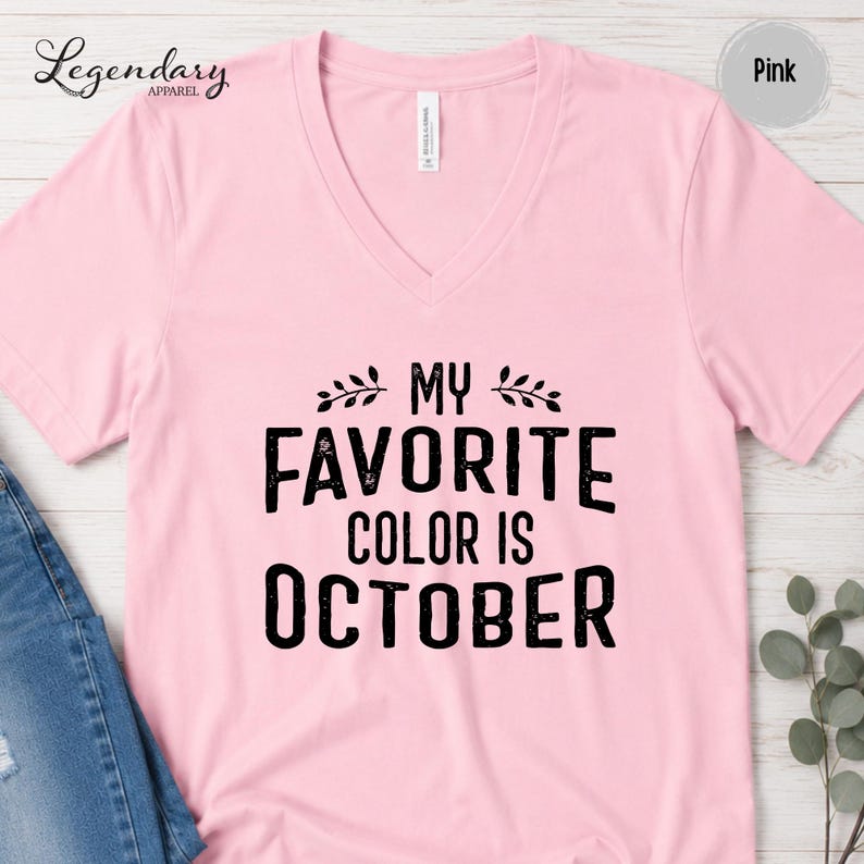 A pink t-shirt with the text "My favorite color is October" printed on it.