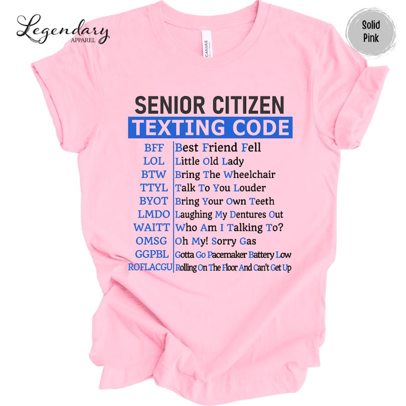 May include: Pink t-shirt with the text "Senior Citizen Texting Code" and a list of common senior citizen texting abbreviations and their meanings.
