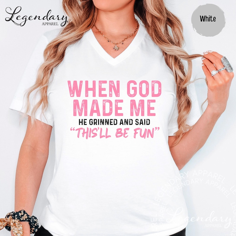 A woman wearing a white t-shirt with text printed on it.