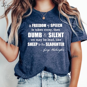May include: Navy blue t-shirt with the quote "If freedom of speech is taken away, then dumb & silent we may be lead, like sheep to the slaughter - George Washington" in white text. The shirt is a crew neck.