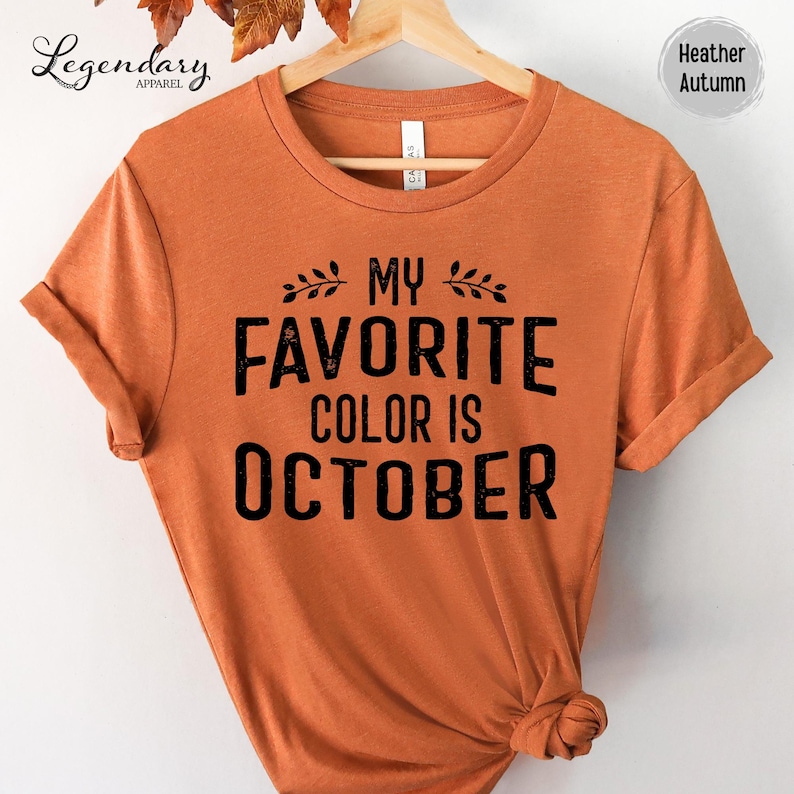 a bright orange t-shirt with the text "My favorite color is October" printed on it.