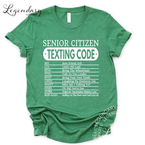The image is a green t-shirt with white text that reads "SENIOR CITIZEN TEXTING CODE" printed on it.