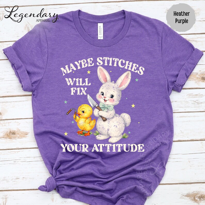 The image is a purple t-shirt with a cartoon rabbit and a yellow duck, along with the text "MAYBE STITCHS WILL FIX YOUR ATTITUDE" printed on it.