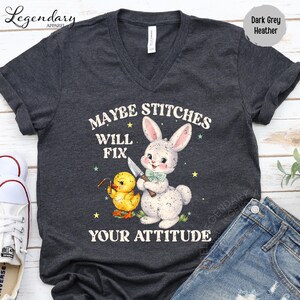 a gray t-shirt with a cartoon rabbit and a yellow duck, along with the text "MAYBE STITCHS WILL FIX YOUR ATTITUDE".