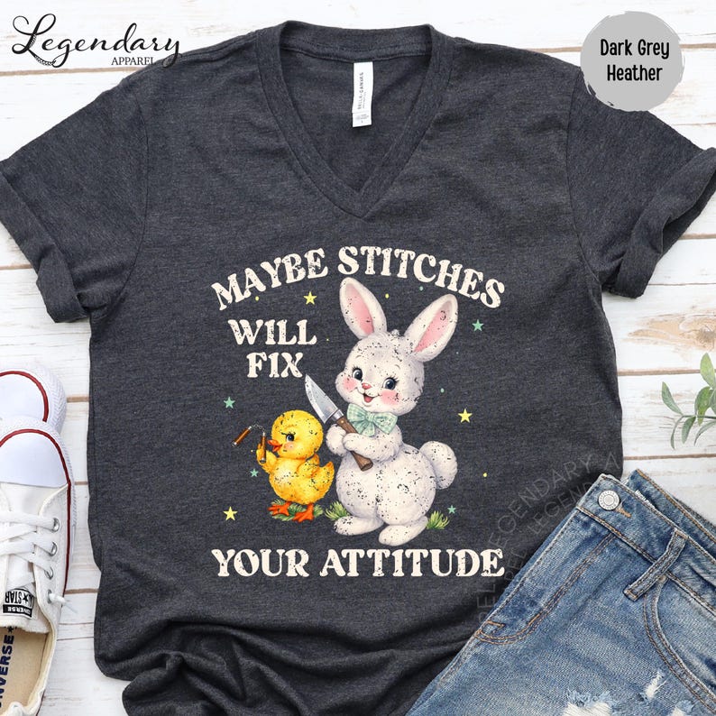 a gray t-shirt with a cartoon rabbit and a yellow duck, along with the text "MAYBE STITCHS WILL FIX YOUR ATTITUDE".