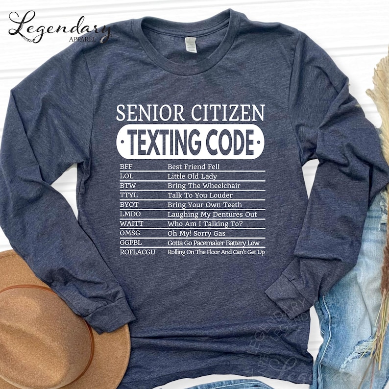 A gray long-sleeved t-shirt with a humorous text list printed on it, which appears to be a " Senior Citizen Texting Code" or a list of rules for senior citizens to follow when texting.