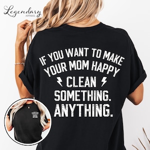 May include: Black t-shirt with white text that reads "IF YOU WANT TO MAKE YOUR MOM HAPPY CLEAN SOMETHING. ANYTHING." The shirt has short sleeves and a relaxed fit. The brand logo "Legendary Apparel" is visible in the upper left corner.