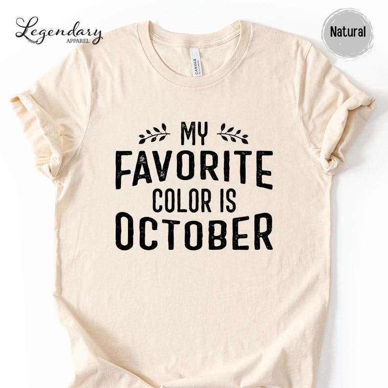 a beige t-shirt with a black text design that reads "My favorite color is October".