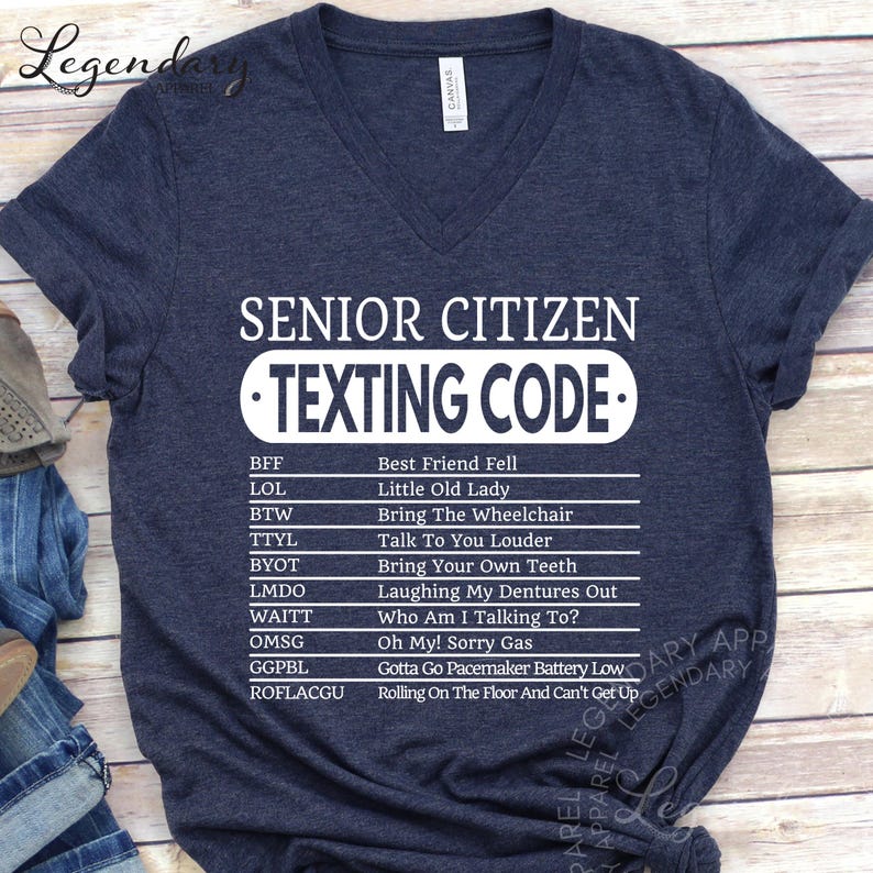 A dark blue t-shirt with a humorous text that reads "SENIOR CITIZEN TEXTING CODE" printed on it.
