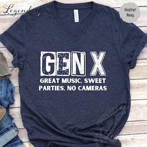 A navy blue t-shirt with the text "GENX" printed on it, along with the text "GREAT MUSIC, SWEET PARTIES, NO CAMERAS" below it.
