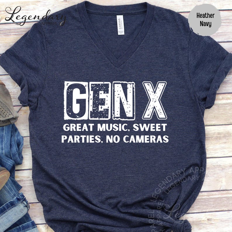 A navy blue t-shirt with the text "GENX" printed on it, along with the text "GREAT MUSIC, SWEET PARTIES, NO CAMERAS" below it.