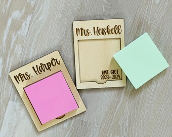 May include: Two wooden note holders with personalized names, "Mrs. Harper" and "Mrs. Heiskell". The holder for Mrs. Heiskell also has the text "Love Gtgt 2023-2024".