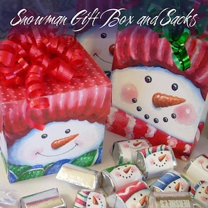 May include: A set of snowman gift boxes and sacks. The boxes are red and white with a snowman face on the front. The sacks are red and white with a snowman face on the front. The boxes and sacks are filled with small candy bars wrapped in snowman-themed foil.
