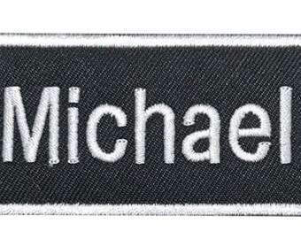 Matt A black work shirt patch that says Matt in white print