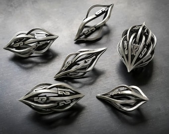 May include: Six silver metal ornaments with intricate designs and numbers. The ornaments are shaped like a sphere, a teardrop, and a leaf.