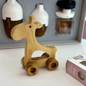 Wooden toy giraffe on wheels